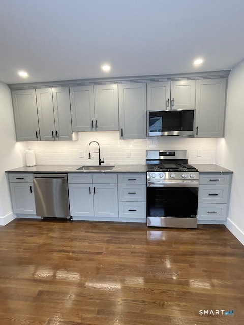 1 Cedar Road Danbury, CT 06811 - Photo 6 of 24 a kitchen with stainless steel appliances granite countertop a stove a sink and a microwave