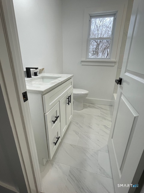 1 Cedar Road Danbury, CT 06811 - Photo 9 of 24 a bathroom with a sink a mirror and a toilet