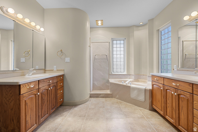 389 North Main Street St. George, UT 84770 - Photo 16 of 44 Bathroom featuring two vanities, a bath, a stall shower, and light tile patterned flooring