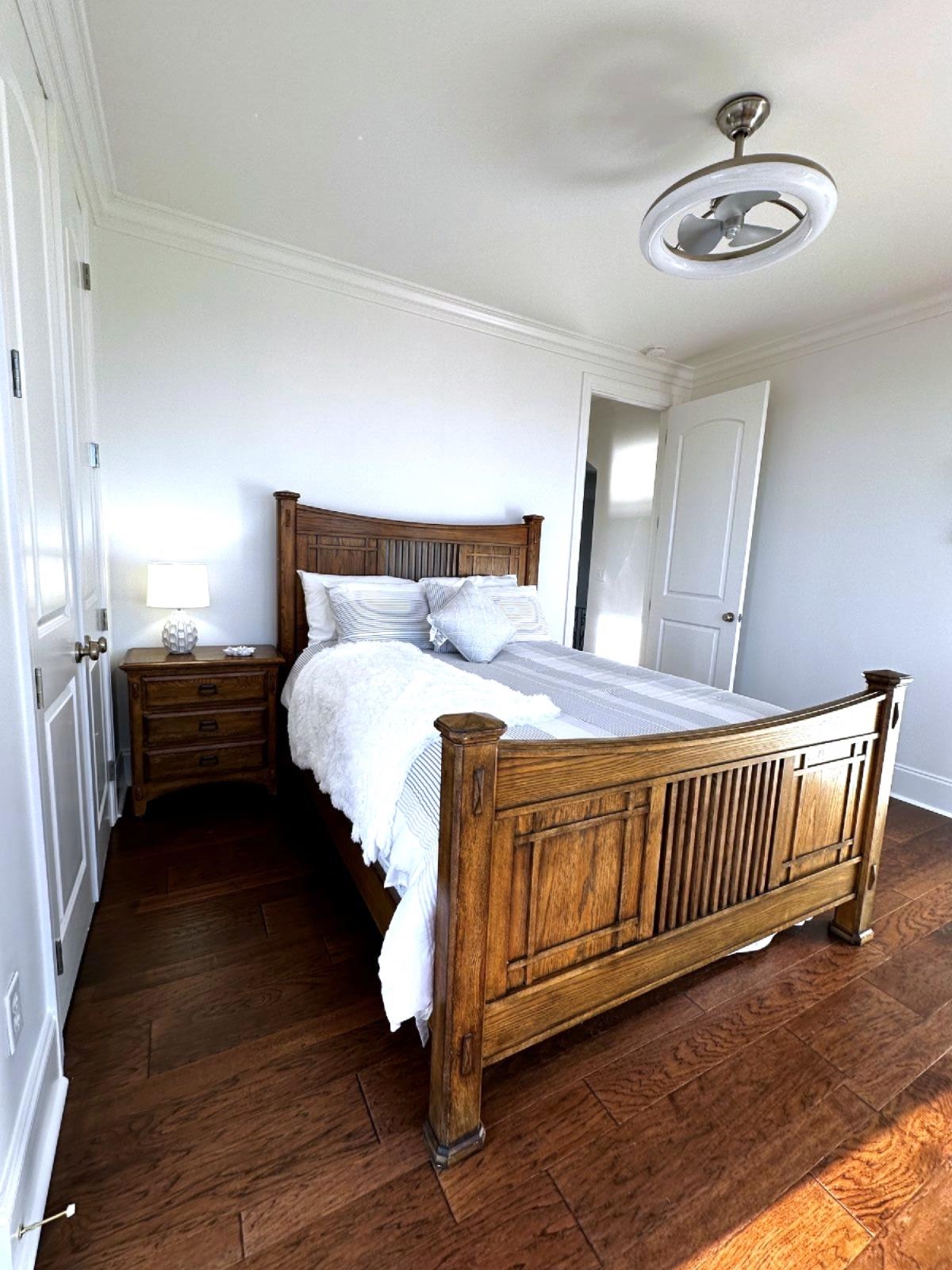 115 Westshore Ridge Savannah, TN 38372 - Photo 15 of 21 a spacious bedroom with a bed and a chandelier