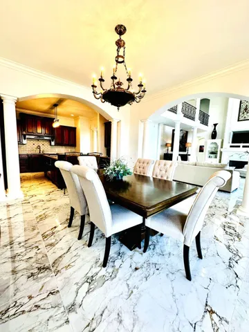 a view of a livingroom with furniture and kitchen view
