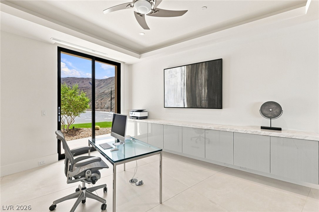 677 Overlook Rim Drive Henderson, NV 89012 - Photo 29 of 97 Sliding glass doors open to reveal scenic mountain views from this contemporary workspace.