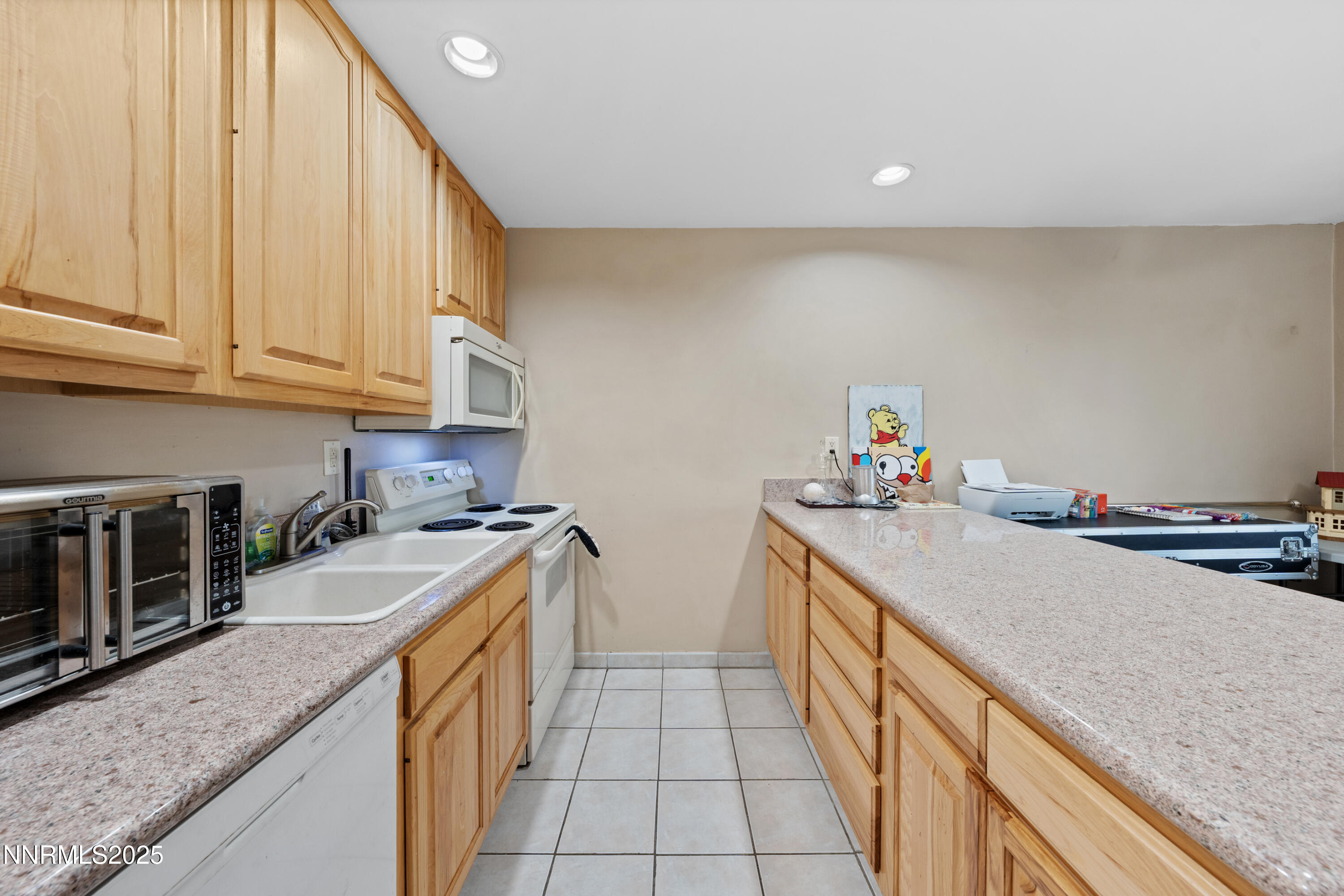 3031 Cashill Boulevard Reno, NV 89509 - Photo 6 of 22 a kitchen with granite countertop a sink and cabinets