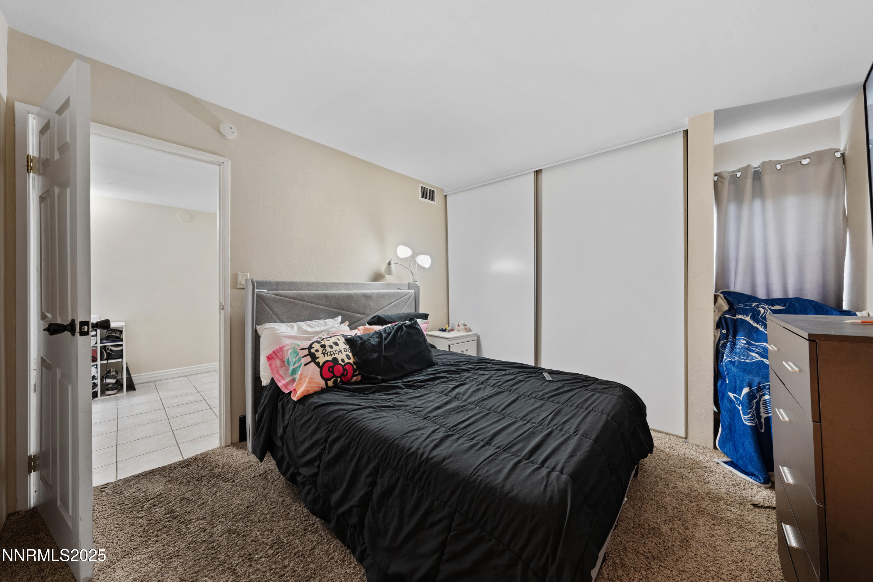 3031 Cashill Boulevard Reno, NV 89509 - Photo 7 of 22 a bedroom with a bed and a mirror