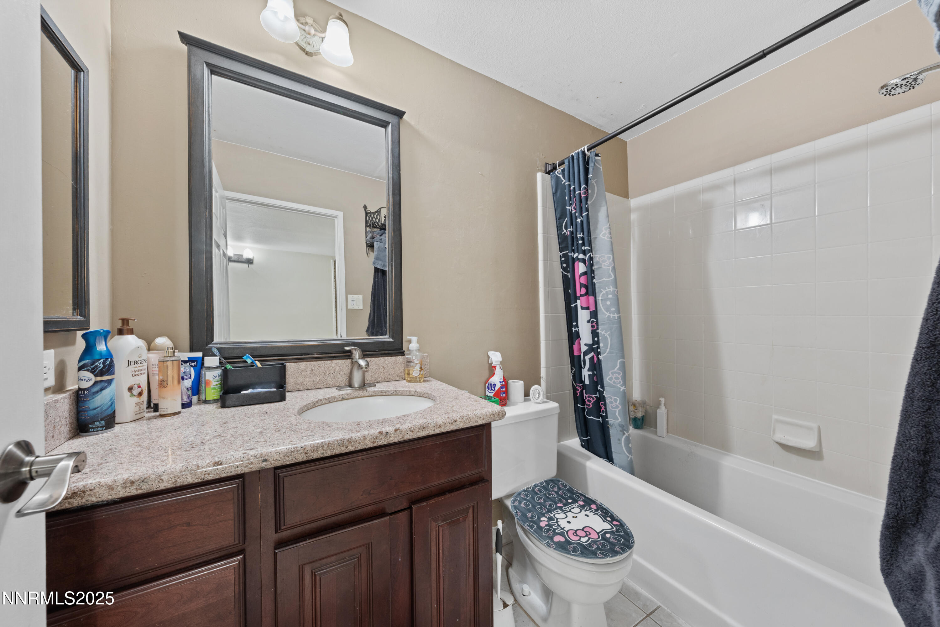 3031 Cashill Boulevard Reno, NV 89509 - Photo 10 of 22 a bathroom with a granite countertop sink and a mirror