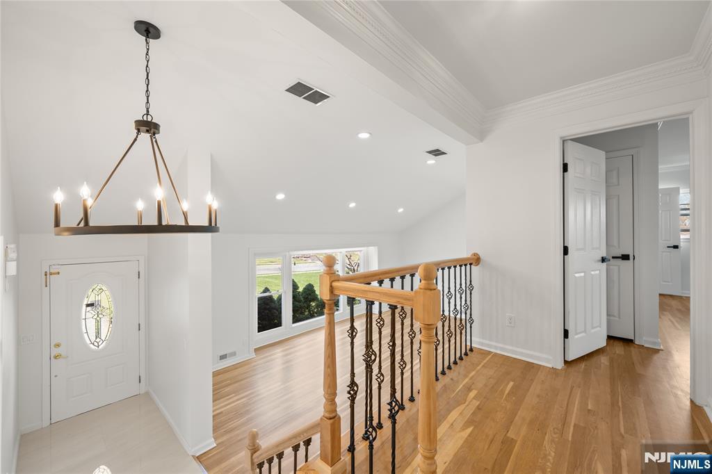 181 Haddenfield Road Clifton, NJ 07013 - Photo 19 of 34 a view of a hallway with wooden floor and stairs