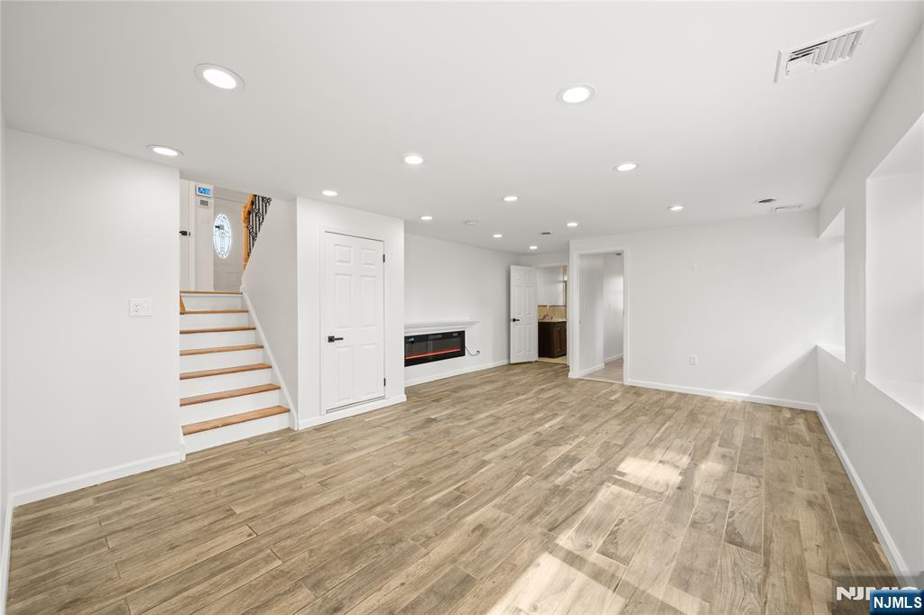 181 Haddenfield Road Clifton, NJ 07013 - Photo 20 of 34 a view of a hallway with stairs and a kitchen view