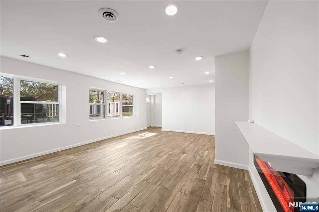 181 Haddenfield Road Clifton, NJ 07013 - Photo 21 of 34 a view of an empty room with wooden floor and a window