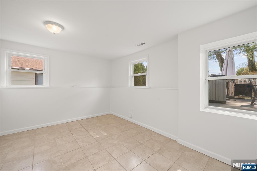 181 Haddenfield Road Clifton, NJ 07013 - Photo 23 of 34 an empty room with windows and closet