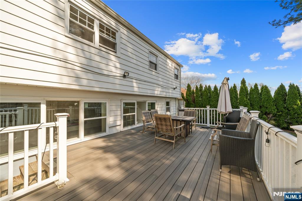 181 Haddenfield Road Clifton, NJ 07013 - Photo 27 of 34 a view of a roof deck with table and chairs a barbeque with wooden floor and fence
