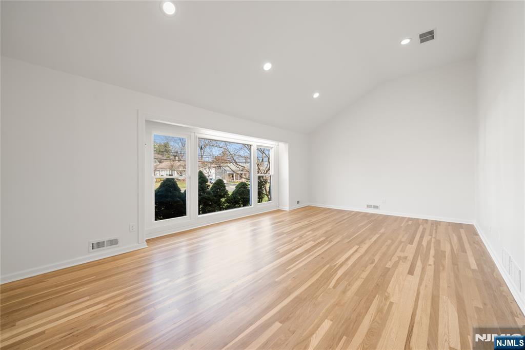 181 Haddenfield Road Clifton, NJ 07013 - Photo 3 of 34 a view of an empty room with wooden floor and a window