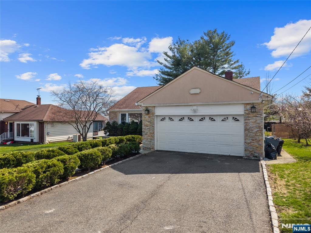 181 Haddenfield Road Clifton, NJ 07013 - Photo 33 of 34 a front view of a house with a yard and garage