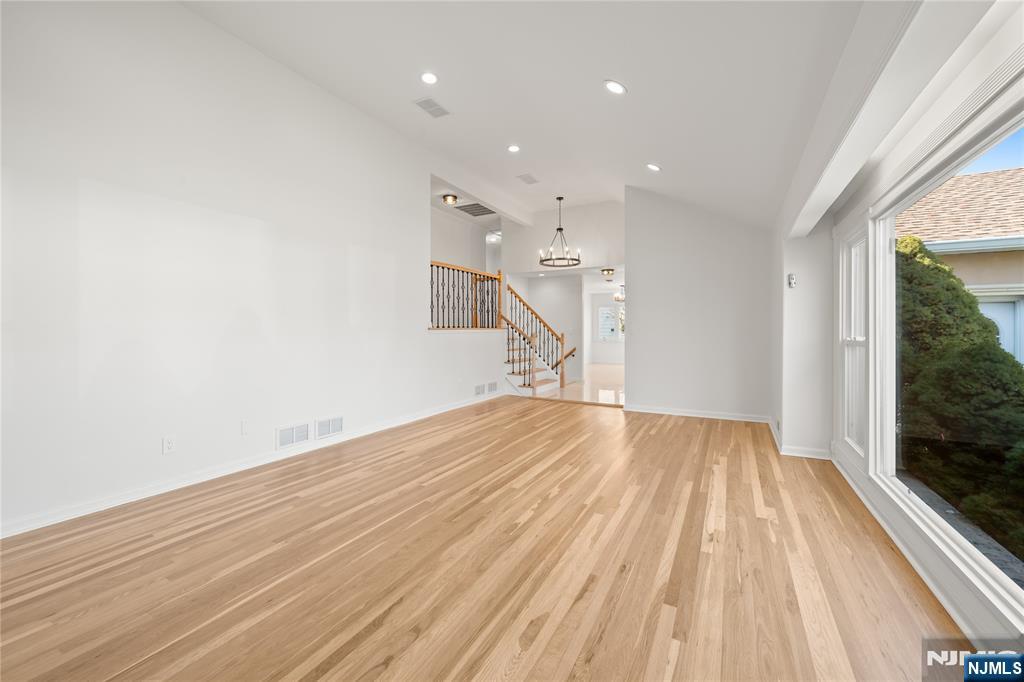 181 Haddenfield Road Clifton, NJ 07013 - Photo 5 of 34 a view of empty room with wooden floor and fan