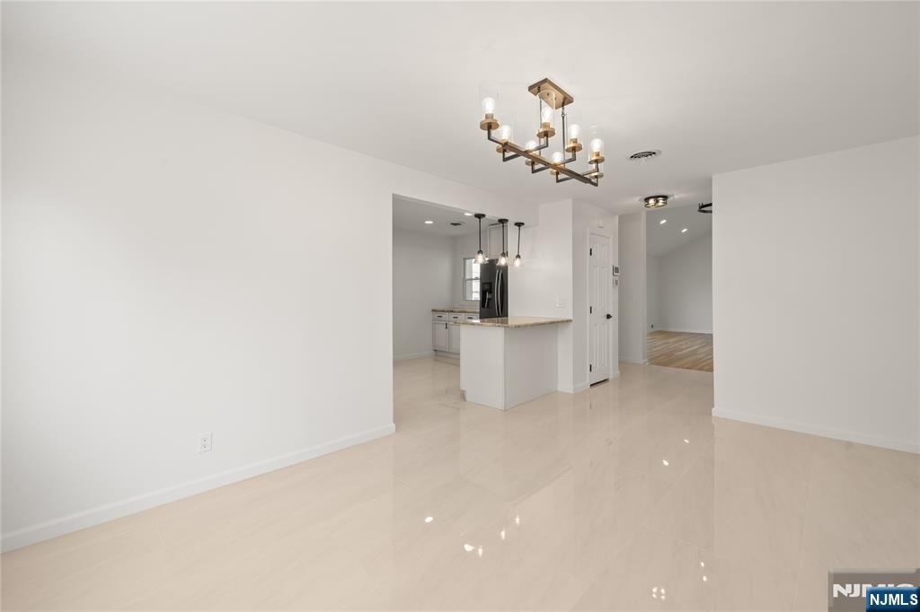 181 Haddenfield Road Clifton, NJ 07013 - Photo 6 of 34 a view of a living room with a white cabinet and a chandelier