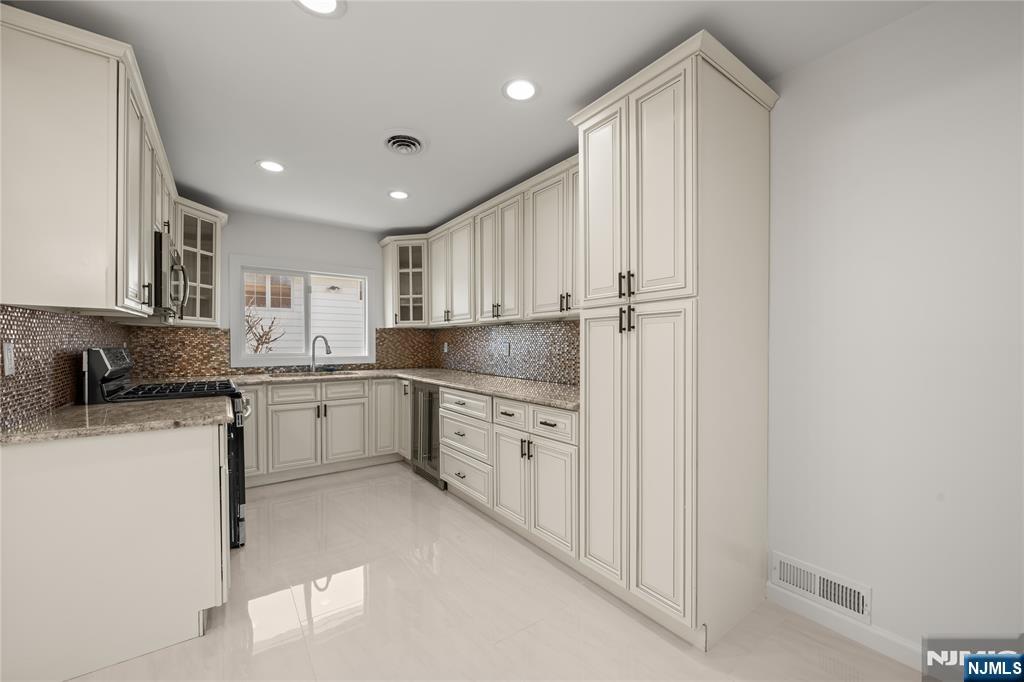 181 Haddenfield Road Clifton, NJ 07013 - Photo 10 of 34 a kitchen with granite countertop cabinets stainless steel appliances and a sink