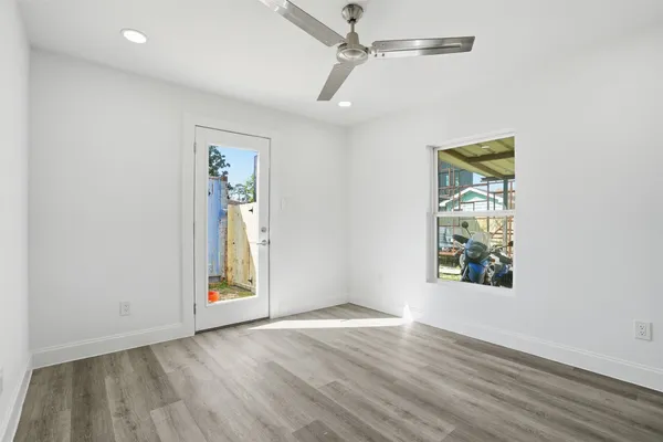 an empty room with wooden floor and closet