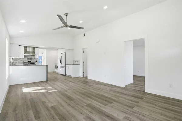 a view of kitchen and hall with wooden floor