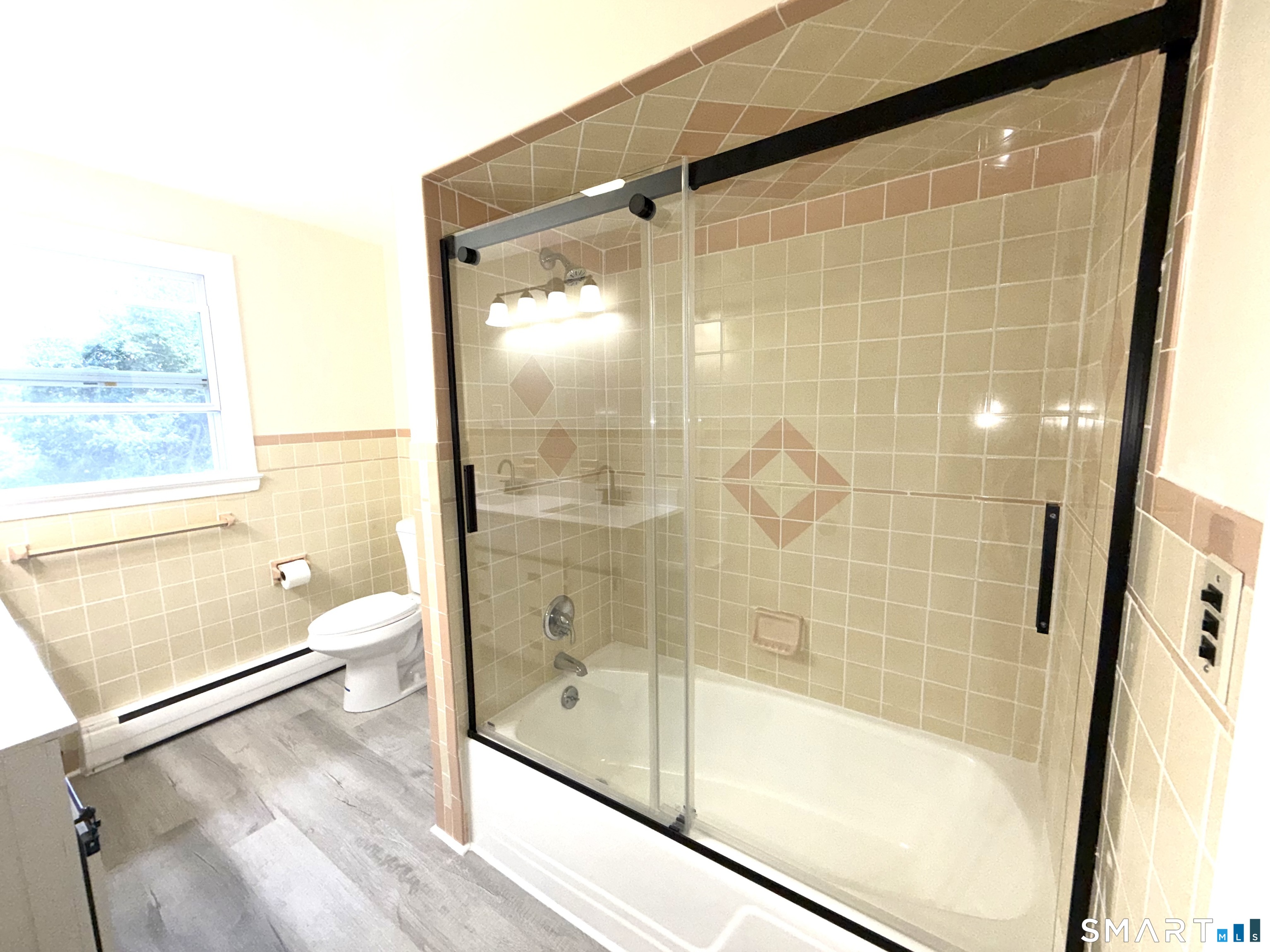341 Harland Road Norwich, CT 06360 - Photo 20 of 29 a bathroom with a glass shower door