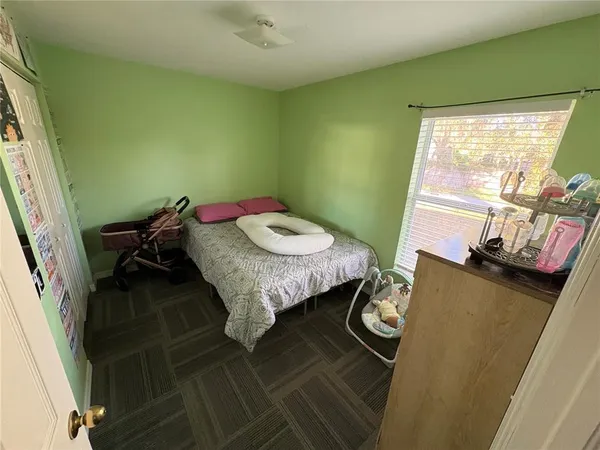a bed sitting in a bedroom next to a window