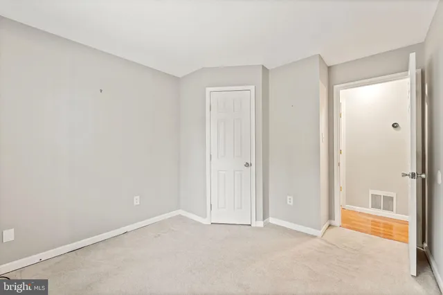 a view of an empty room and closet area
