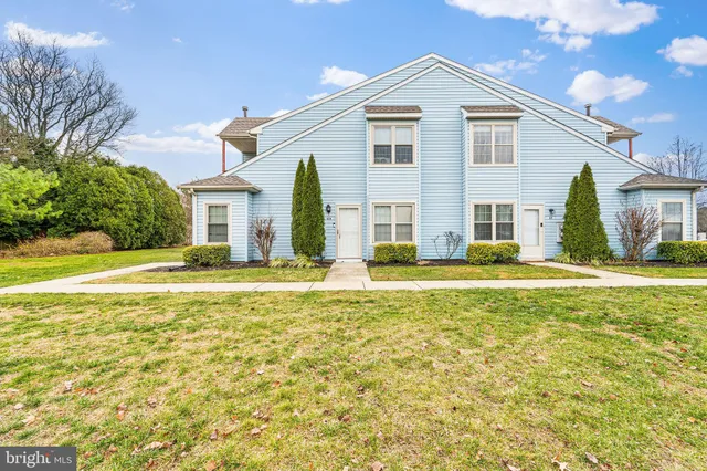 a view of a white house with a large pool and a yard