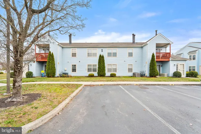 a view of a white house with a patio