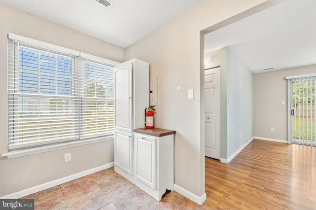 a view of a room with wooden floor and windows