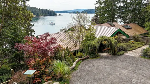 a view of a house with a yard and lake