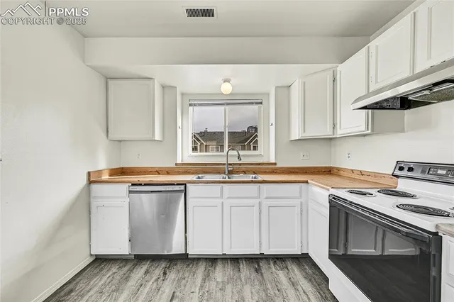 a kitchen with stainless steel appliances granite countertop a stove and a sink