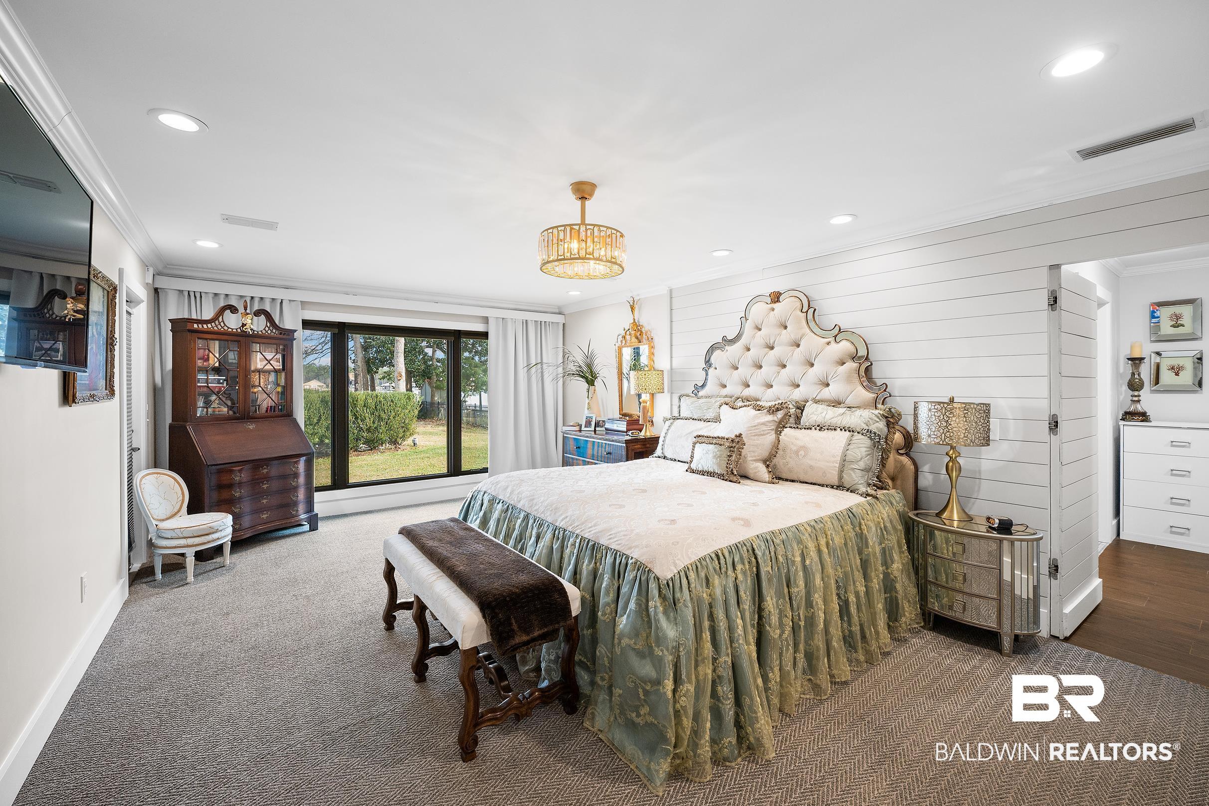 8490 Bay View Drive Foley, AL 36535 - Photo 37 of 67 Bedroom with recessed lighting, ornamental molding, and a chandelier