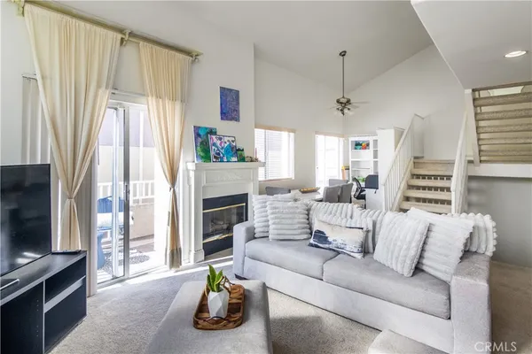 a living room with furniture a fireplace and a flat screen tv