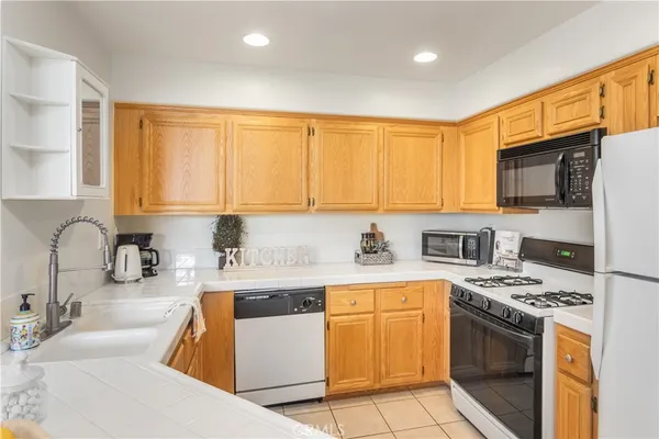 a kitchen with stainless steel appliances a sink a stove a microwave cabinets and a center island