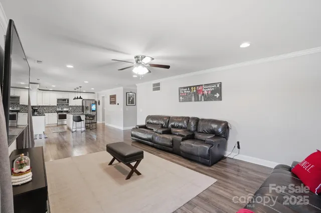 a living room with furniture and kitchen view
