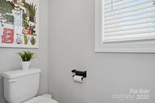 a bathroom with a toilet and a window