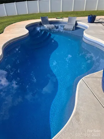 a view of swimming pool with seating area