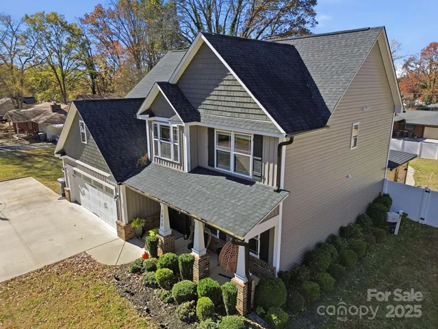 a aerial view of a house with a yard and potted plants