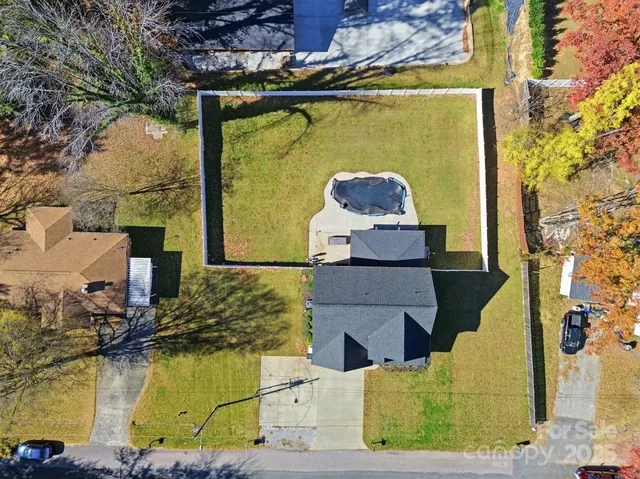 an aerial view of a house with a yard