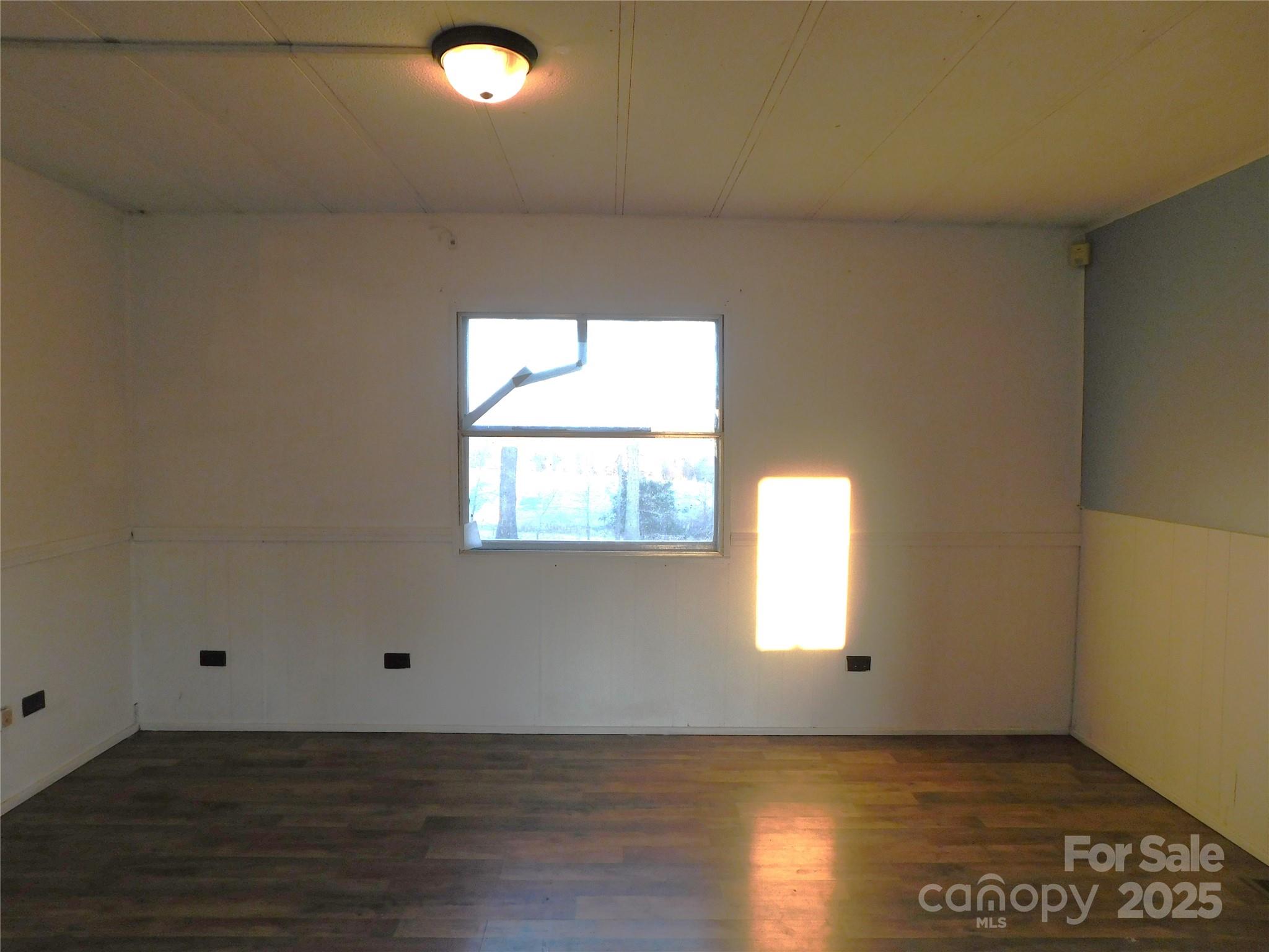 3028 Austin Chaney Road Monroe, NC 28110 - Photo 13 of 16 an empty room with wooden floor and windows