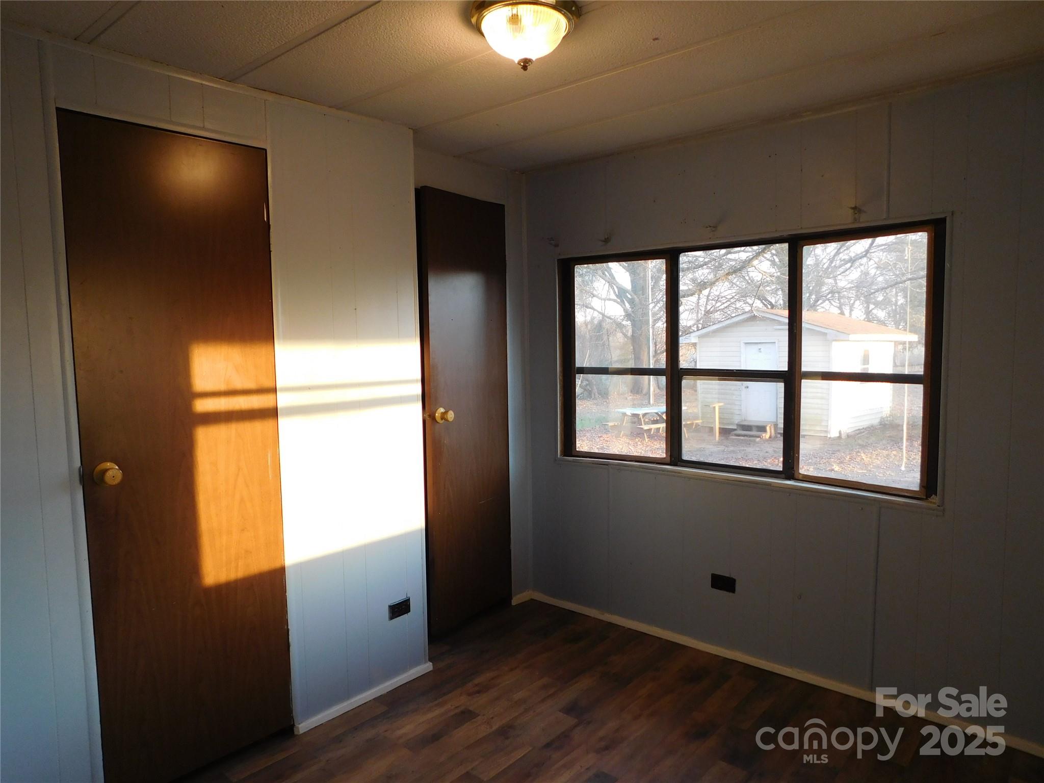 3028 Austin Chaney Road Monroe, NC 28110 - Photo 14 of 16 an empty room with wooden floor and windows