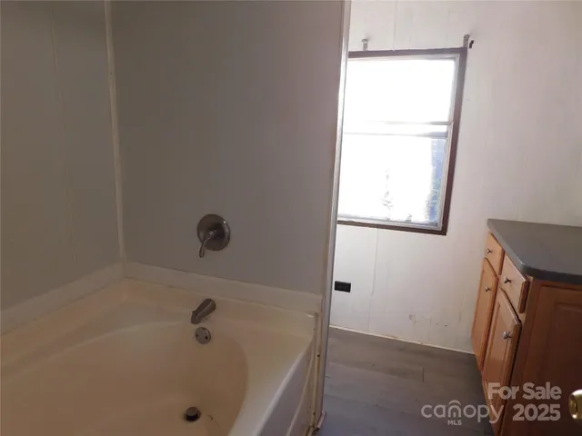 a bathroom with a tub and a window