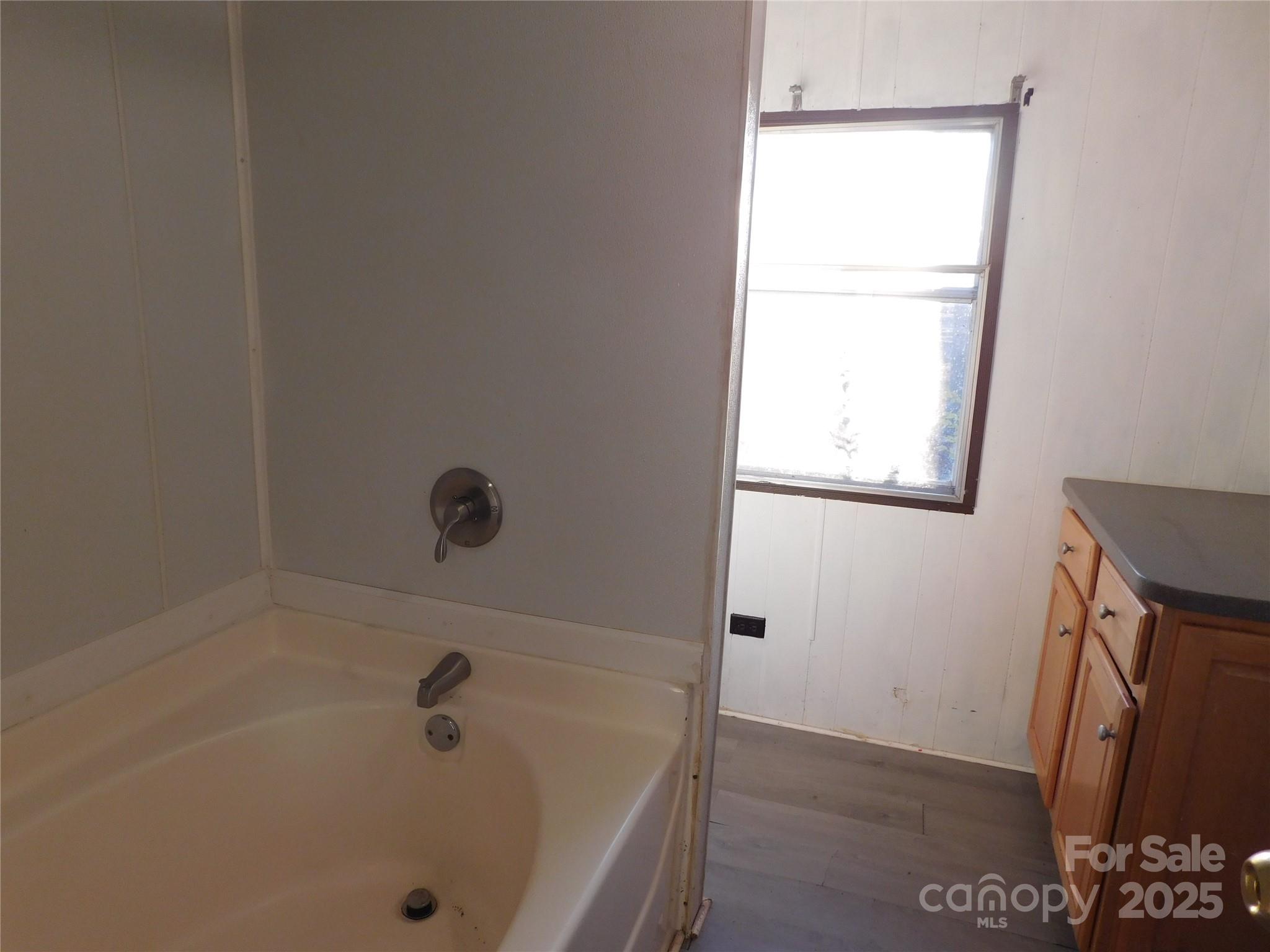3028 Austin Chaney Road Monroe, NC 28110 - Photo 8 of 16 a bathroom with a tub and a window
