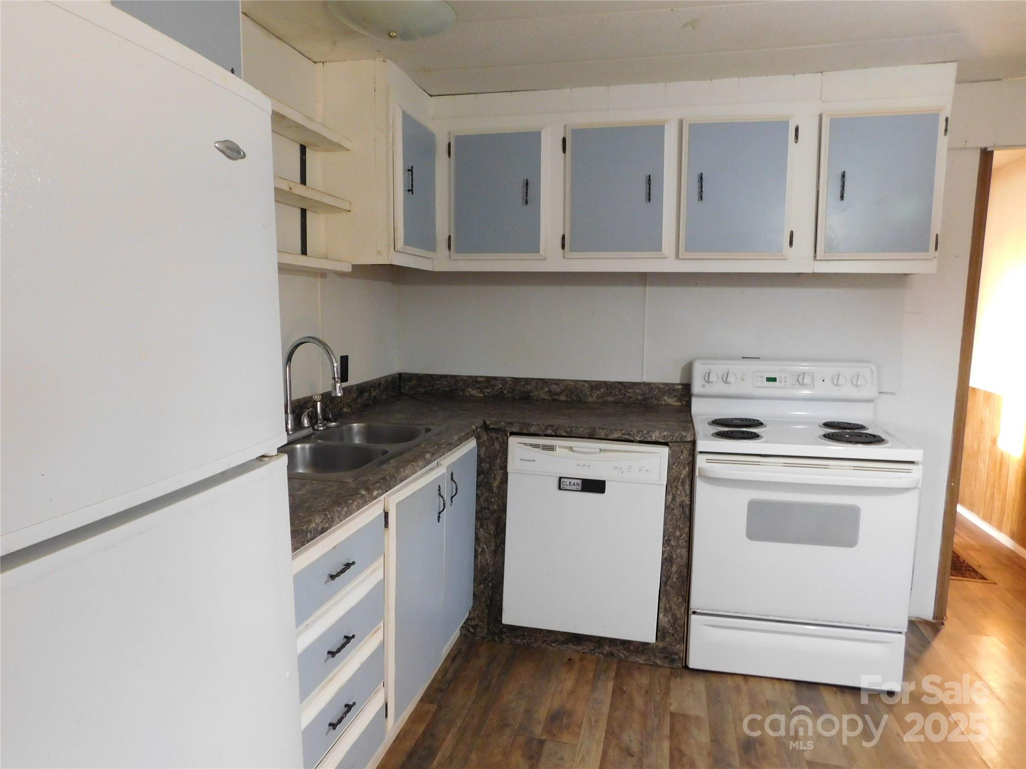 3028 Austin Chaney Road Monroe, NC 28110 - Photo 10 of 16 a kitchen with white cabinets stainless steel appliances and sink