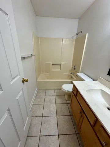 a bathroom with a sink a toilet a mirror and shower