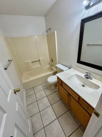 a bathroom with a sink a toilet and mirror