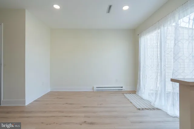 a view of room with window and hardwood floor