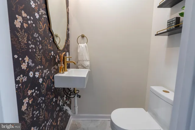 a bathroom with a toilet sink and mirror