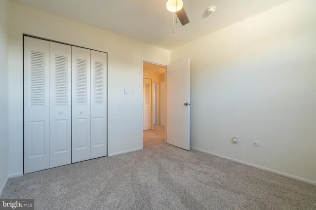 an empty room with closet area