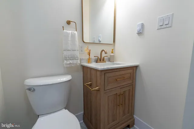 a bathroom with a toilet sink and mirror