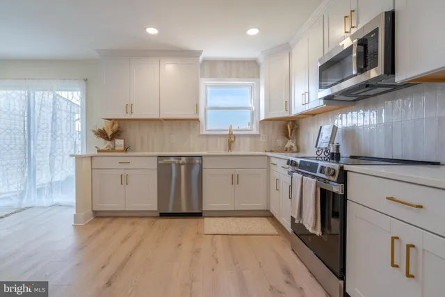 a kitchen with a sink a stove and cabinets