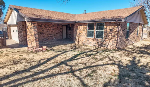 a view of a house with a yard and garage